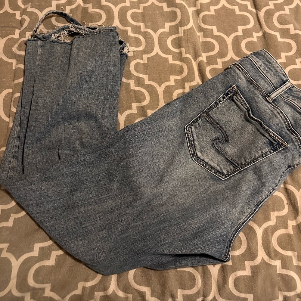 Silver Jeans. Extremely frayed at the bottoms.